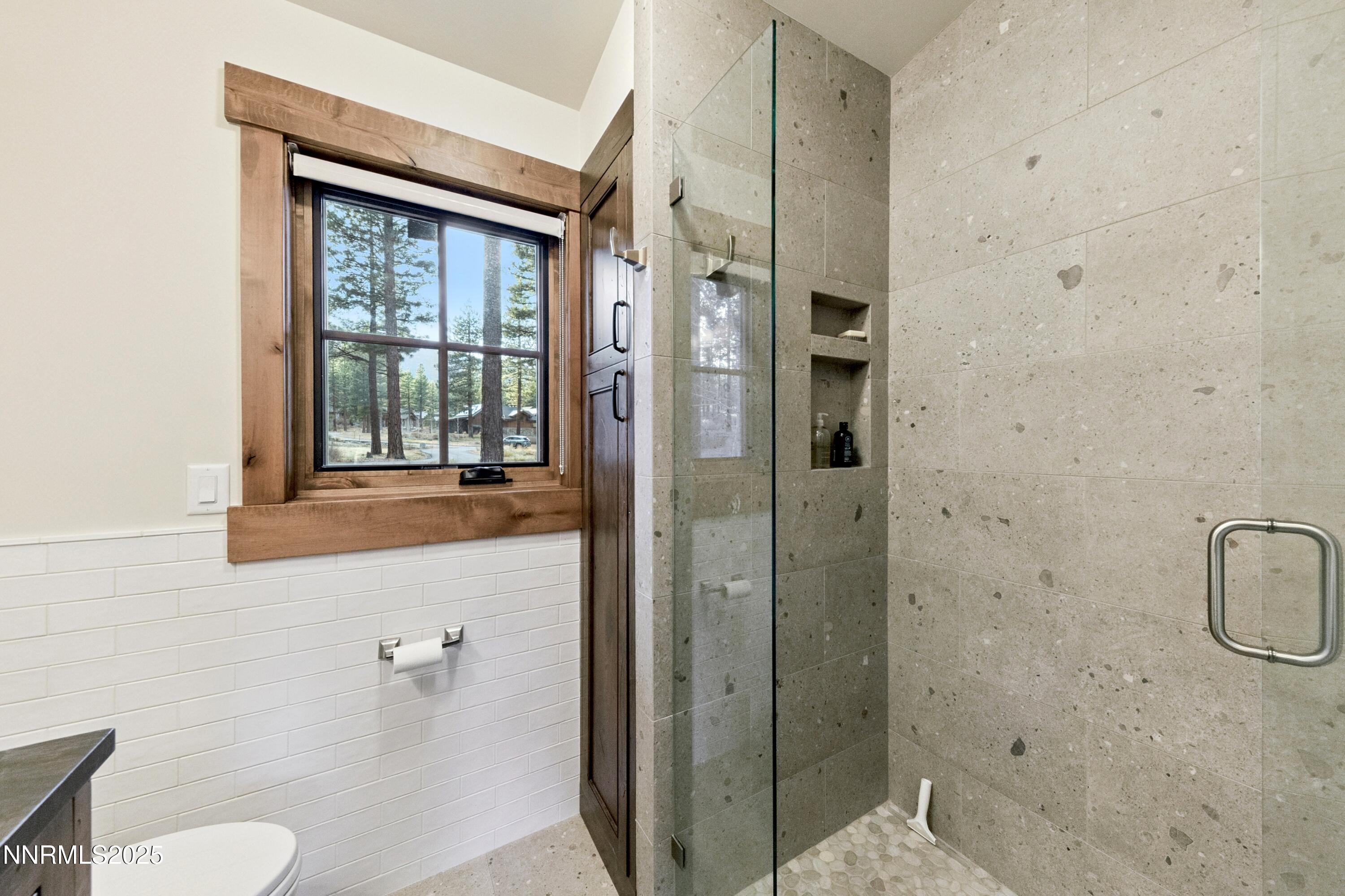 261 Redding Way Carson City, NV 89705 - Photo 52 of 90 a bathroom with a granite countertop sink a mirror and a shower