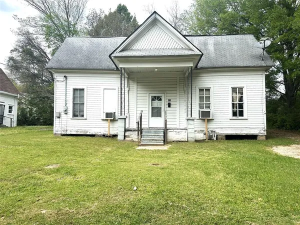 a view of a house with a garden and deck