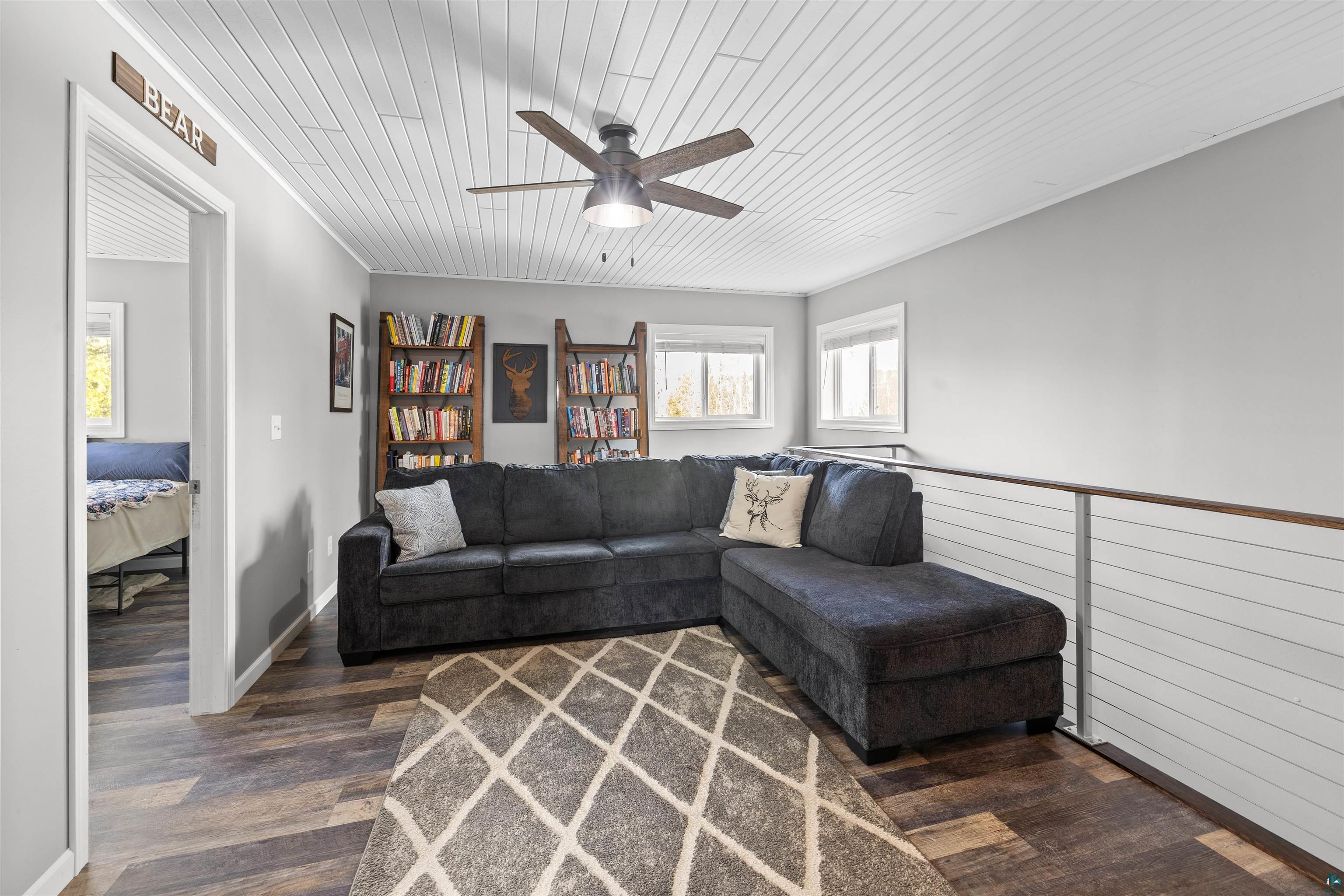 13462 Villa Road Ely, MN 55731 - Photo 9 of 68 Living room featuring Lifeproof flooring, a ceiling fan, and wooden ceiling