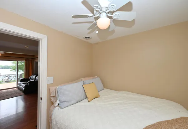 a bedroom with a bed and wooden floor