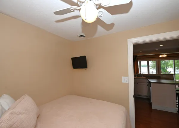 a bedroom with a bed and a chandelier