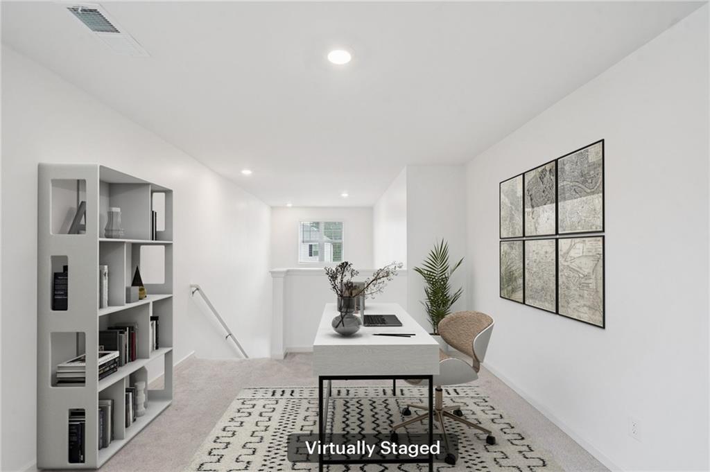 3853 Rustic Barn Way Loganville, GA 30052 - Photo 13 of 22 a view of a workspace with furniture and a potted plant