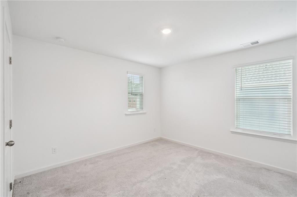 3853 Rustic Barn Way Loganville, GA 30052 - Photo 16 of 22 an empty room with a window