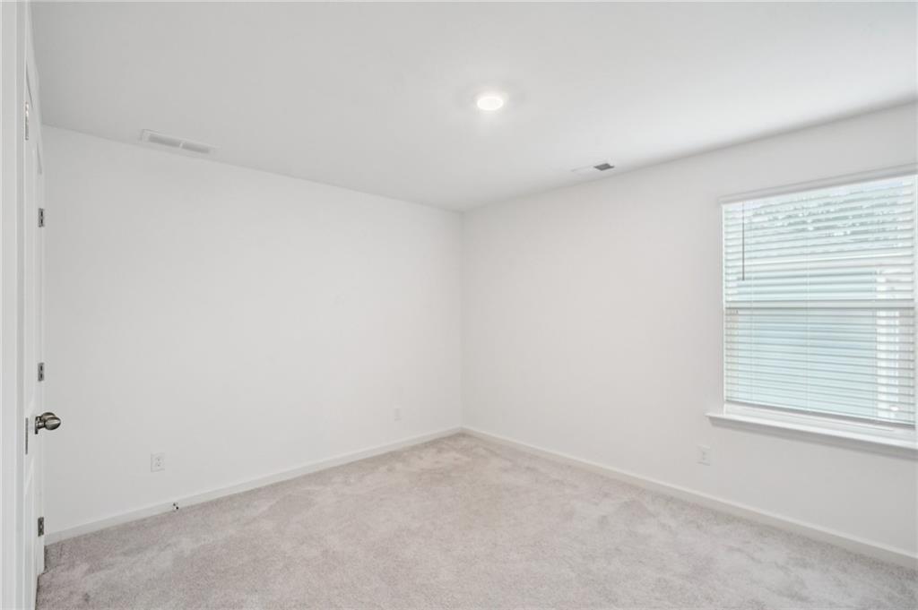 3853 Rustic Barn Way Loganville, GA 30052 - Photo 17 of 22 an empty room with a window