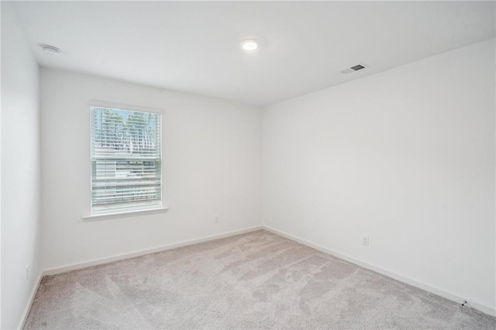 3853 Rustic Barn Way Loganville, GA 30052 - Photo 18 of 22 an empty room with a window