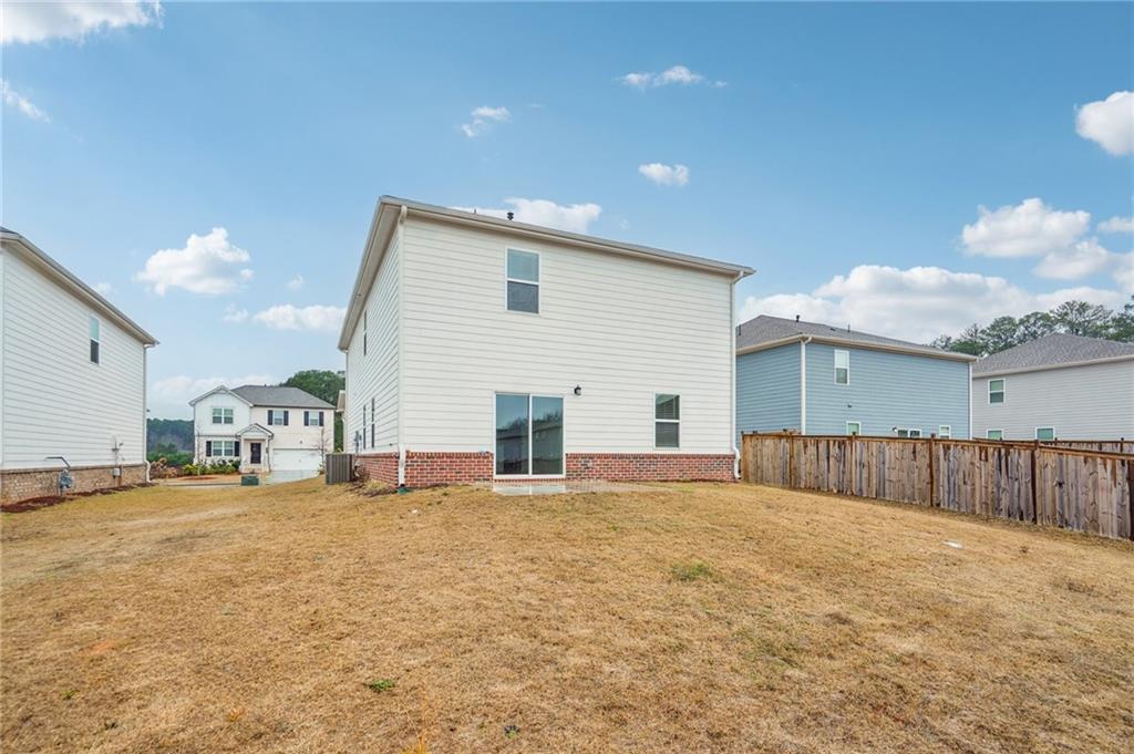3853 Rustic Barn Way Loganville, GA 30052 - Photo 21 of 22 a view of a house with a yard and garage