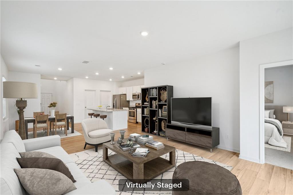 3853 Rustic Barn Way Loganville, GA 30052 - Photo 6 of 22 a living room with furniture and a flat screen tv