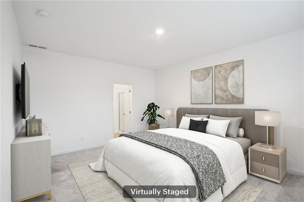 3853 Rustic Barn Way Loganville, GA 30052 - Photo 9 of 22 a bedroom with a bed and a flat screen tv