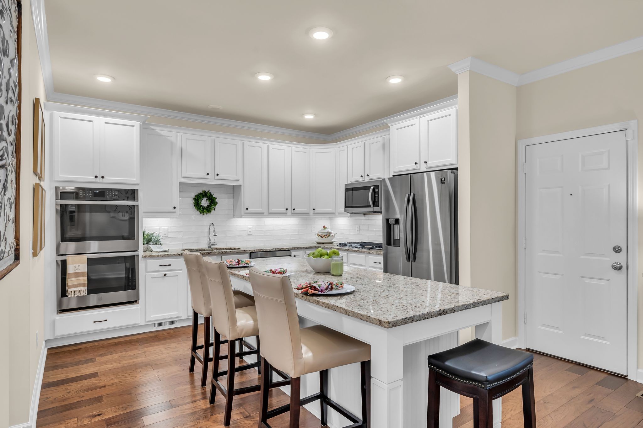 1509 Decatur Circle Franklin, TN 37067 - Photo 8 of 40 a kitchen with stainless steel appliances granite countertop a dining table chairs refrigerator and stove