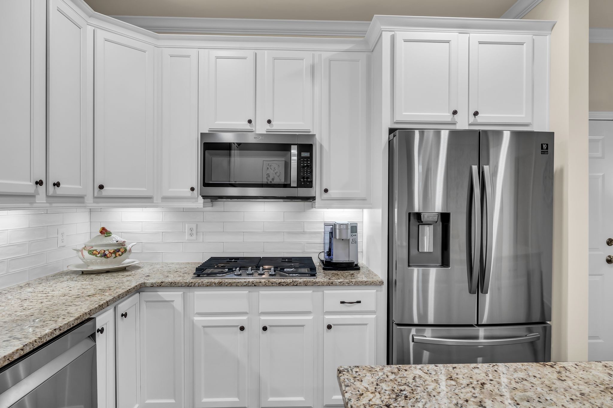 1509 Decatur Circle Franklin, TN 37067 - Photo 10 of 40 a kitchen with granite countertop a refrigerator stove and microwave
