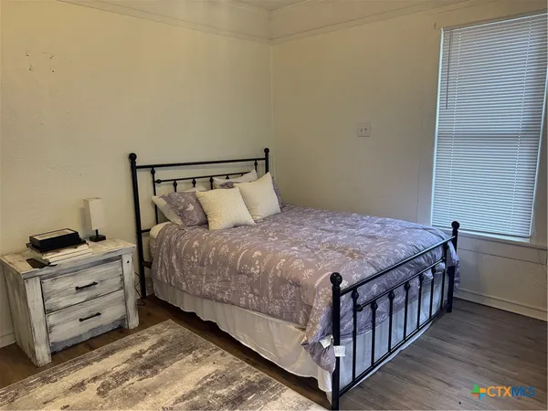 a bedroom with a bed and dresser
