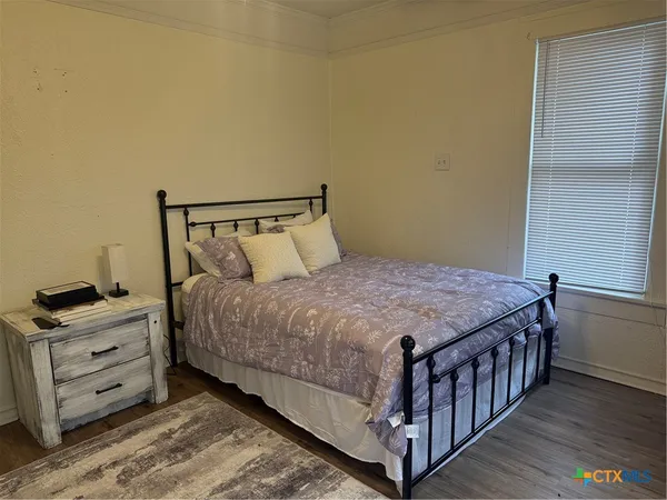 a bedroom with a bed and dresser