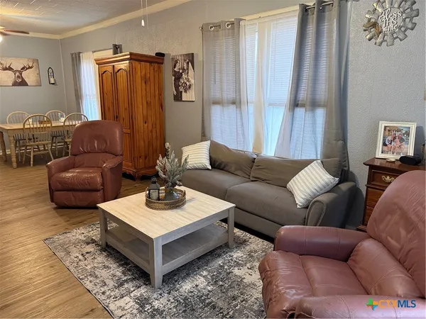 a living room with furniture a rug and a window