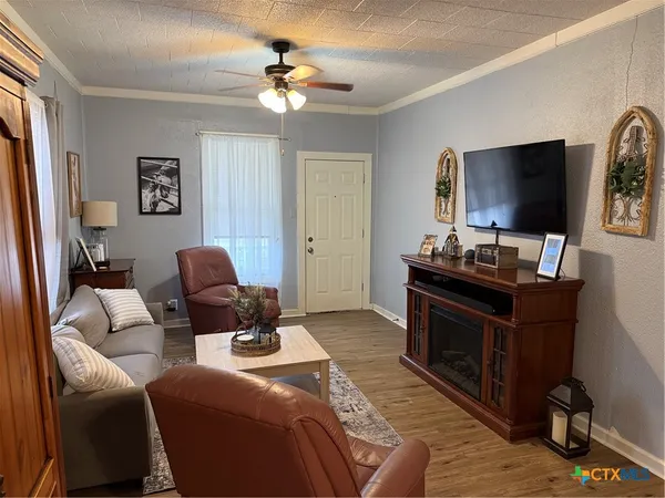 a living room with furniture and a flat screen tv