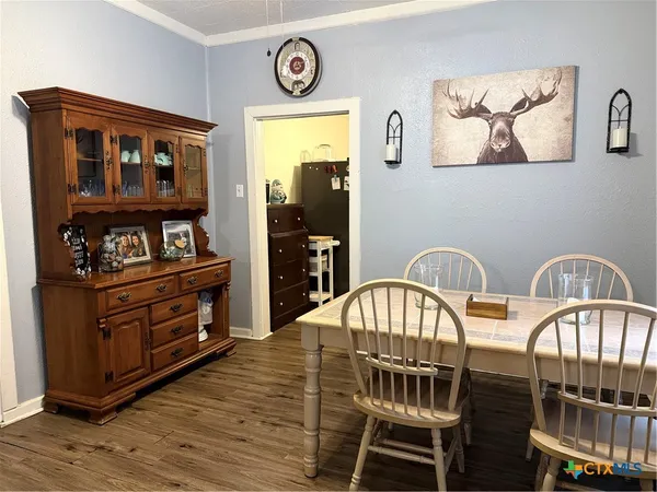a view of a dining room with furniture and chandelier