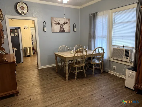 a view of a dining room with furniture window and wooden floor