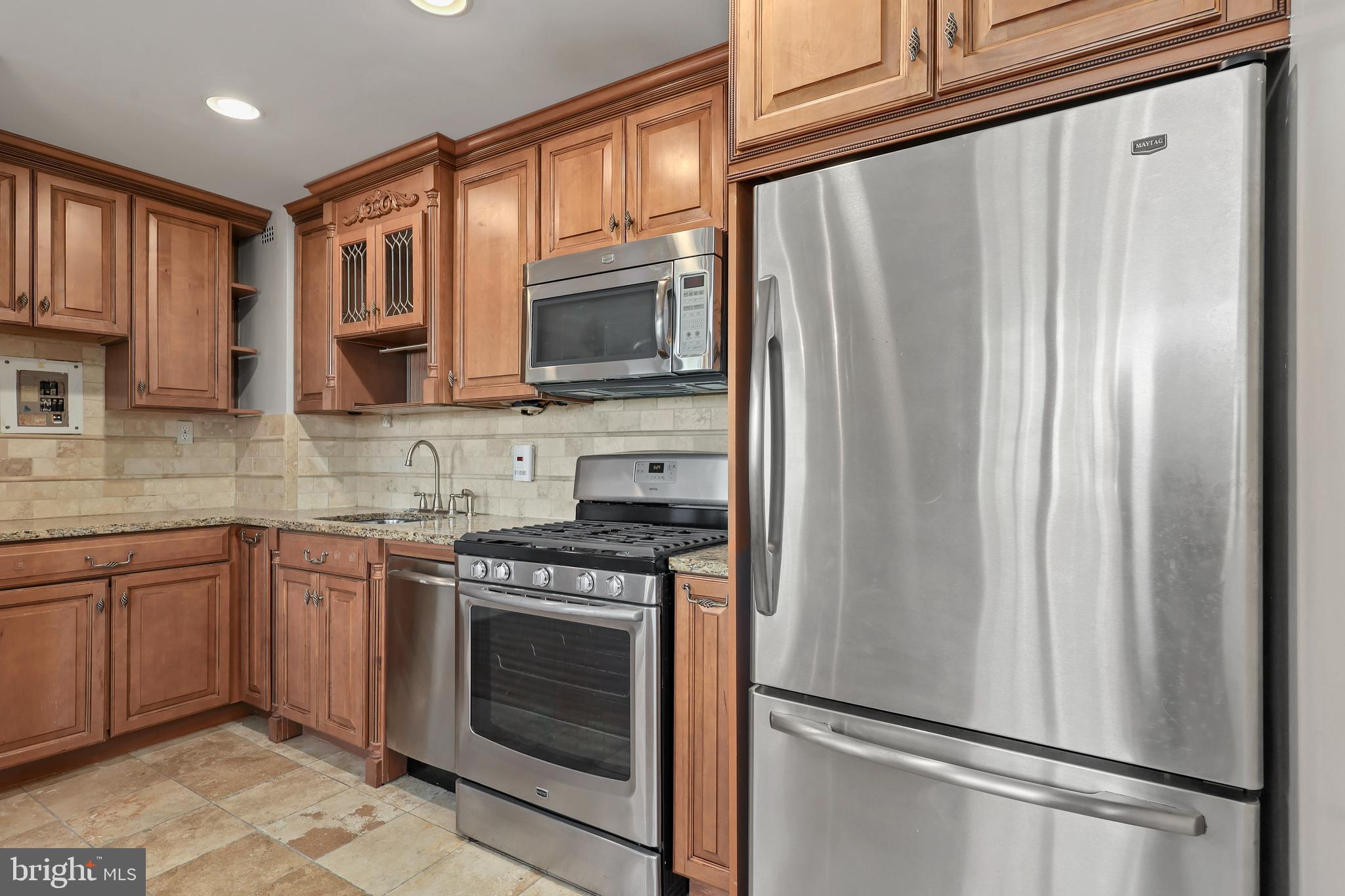 1200 South Arlington Ridge Road, Unit 404 Arlington, VA 22202 - Photo 10 of 32 a kitchen with stainless steel appliances granite countertop a refrigerator sink and stove