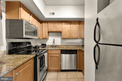 a kitchen with a sink stove and refrigerator