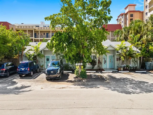 a kitchen with stainless steel appliances wooden floor sink and cabinets