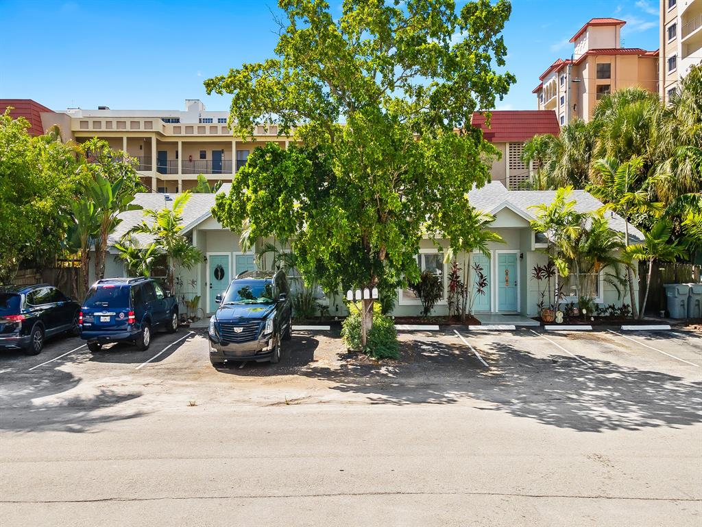 3208 Northeast 7th Street, Unit C Pompano Beach, FL 33062 - Photo 3 of 10 a view of a building with car parked