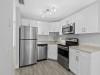 3208 Northeast 7th Street, Unit C Pompano Beach, FL 33062 - Photo 6 of 10 a close view of kitchen with refrigerator cabinets and microwave