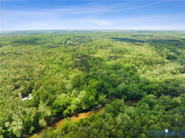 a view of a green field with lots of bushes