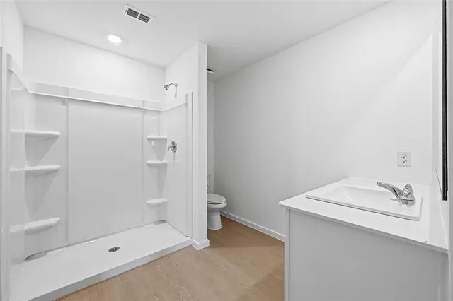 a bathroom with a shower and a sink