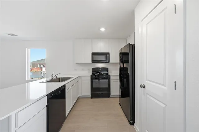 a large kitchen with a refrigerator stove and oven