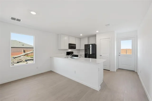 a view of a kitchen with furniture and a window