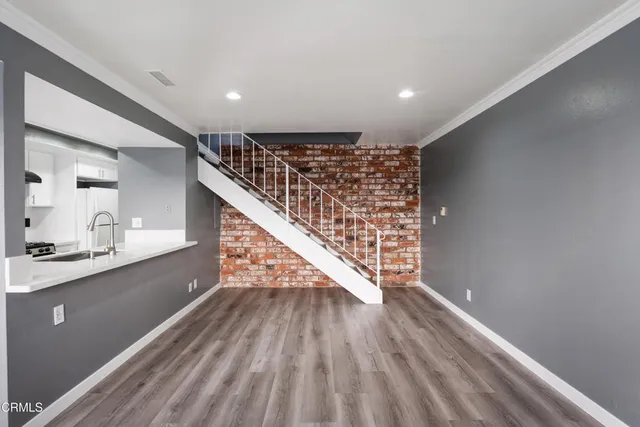 a view of entryway and hall with wooden floor