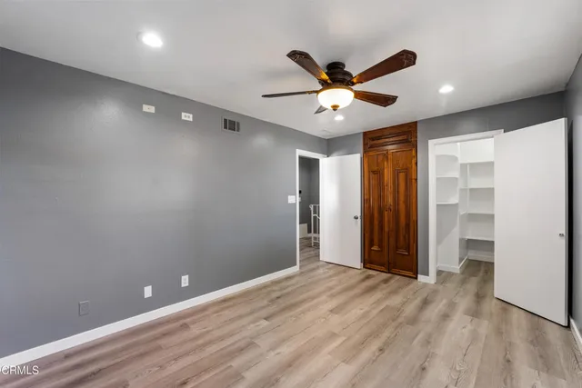 an aerial view of a city with lots of residential buildings and parking space