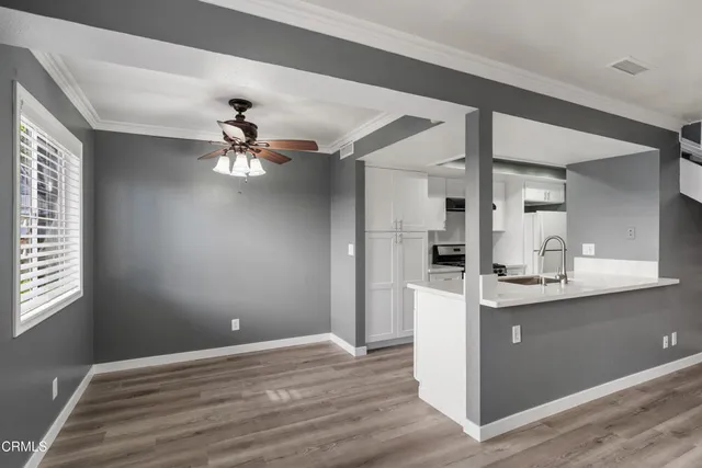 a kitchen with kitchen island granite countertop a sink and a stove top oven