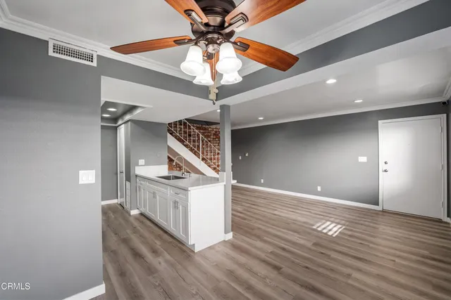 a view of staircase and kitchen with sink