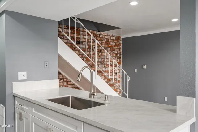 a kitchen with a sink and a refrigerator