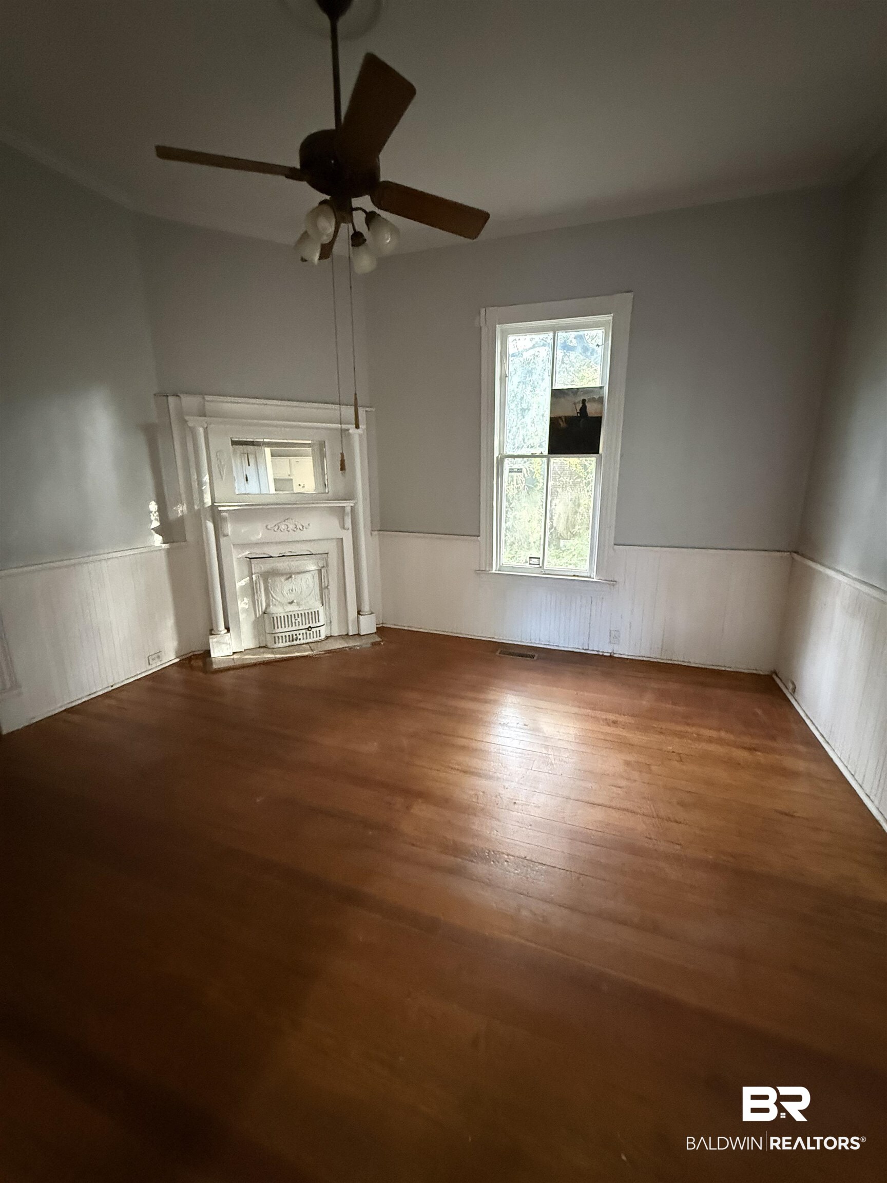 352 South Ann Street Mobile, AL 36604 - Photo 6 of 20 Unfurnished living room featuring wainscoting, ceiling fan, and wood finished floors