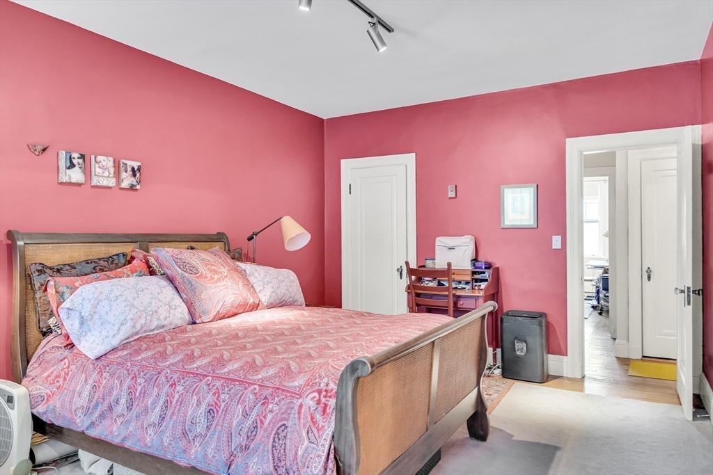 321 Tappan Street, Unit 3 Brookline, MA 02445 - Photo 24 of 39 a bedroom with a bed and a chandelier