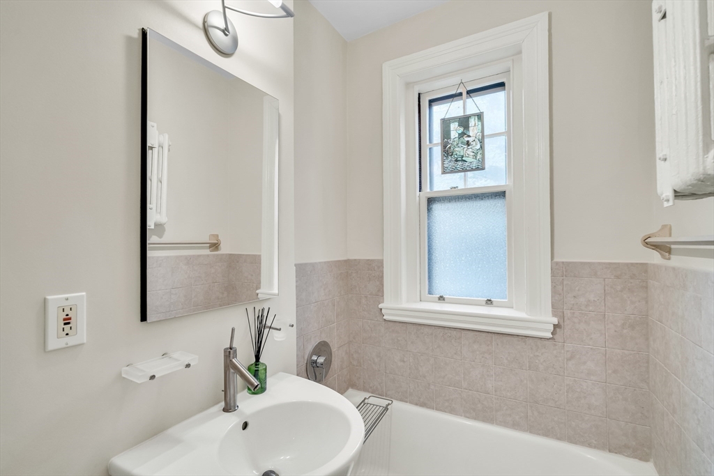 321 Tappan Street, Unit 3 Brookline, MA 02445 - Photo 26 of 39 a bathroom with a sink and a mirror