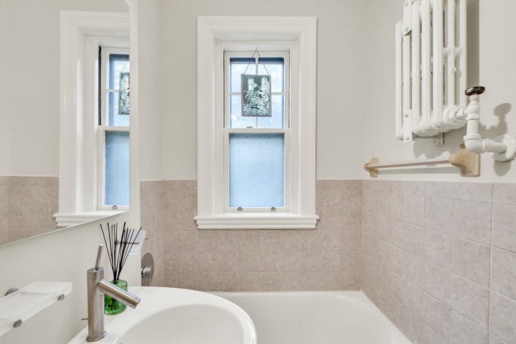 321 Tappan Street, Unit 3 Brookline, MA 02445 - Photo 27 of 39 a bathroom with a sink vanity granite and a toilet