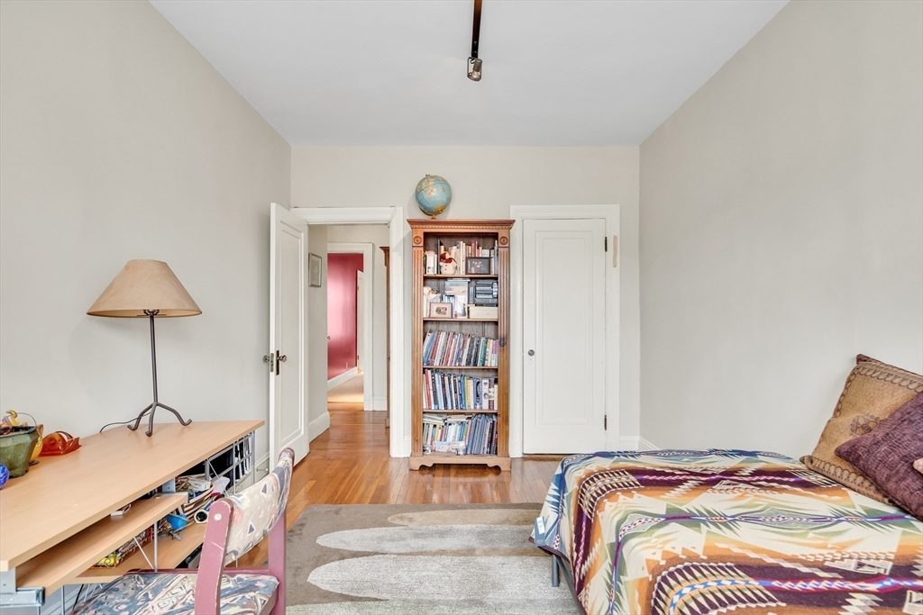 321 Tappan Street, Unit 3 Brookline, MA 02445 - Photo 31 of 39 a bedroom with a bed and a book shelf