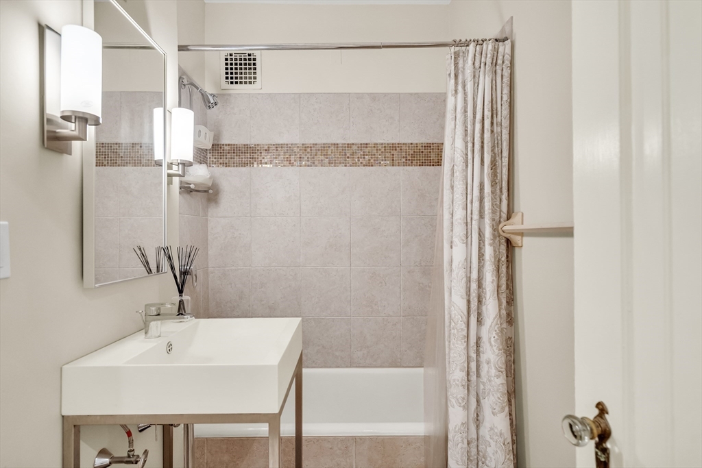 321 Tappan Street, Unit 3 Brookline, MA 02445 - Photo 32 of 39 a bathroom with a sink and a mirror