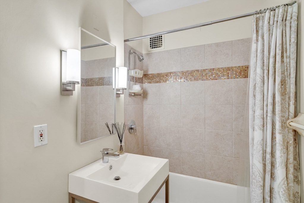 321 Tappan Street, Unit 3 Brookline, MA 02445 - Photo 33 of 39 a bathroom with a sink a mirror and a shower
