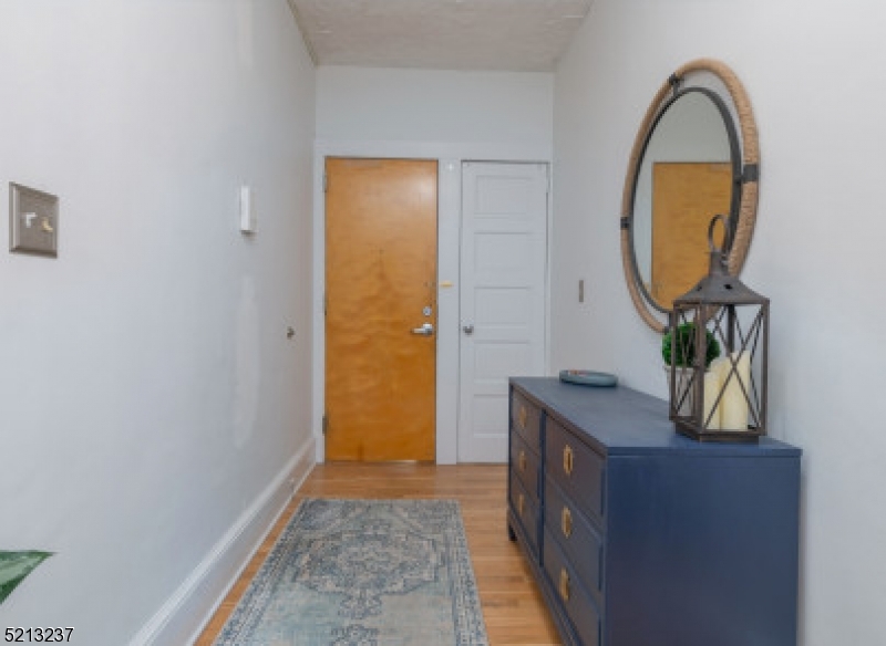 306 Springfield Avenue, Unit 1 Summit, NJ 07901 - Photo 2 of 8 a view of an entryway with sitting space and mirror