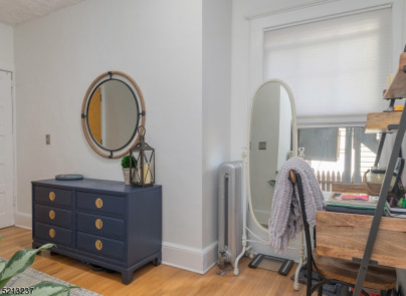306 Springfield Avenue, Unit 1 Summit, NJ 07901 - Photo 3 of 8 a view of a livingroom with furniture and a mirror