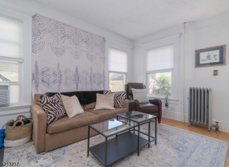 306 Springfield Avenue, Unit 1 Summit, NJ 07901 - Photo 4 of 8 a living room with furniture and wooden floor