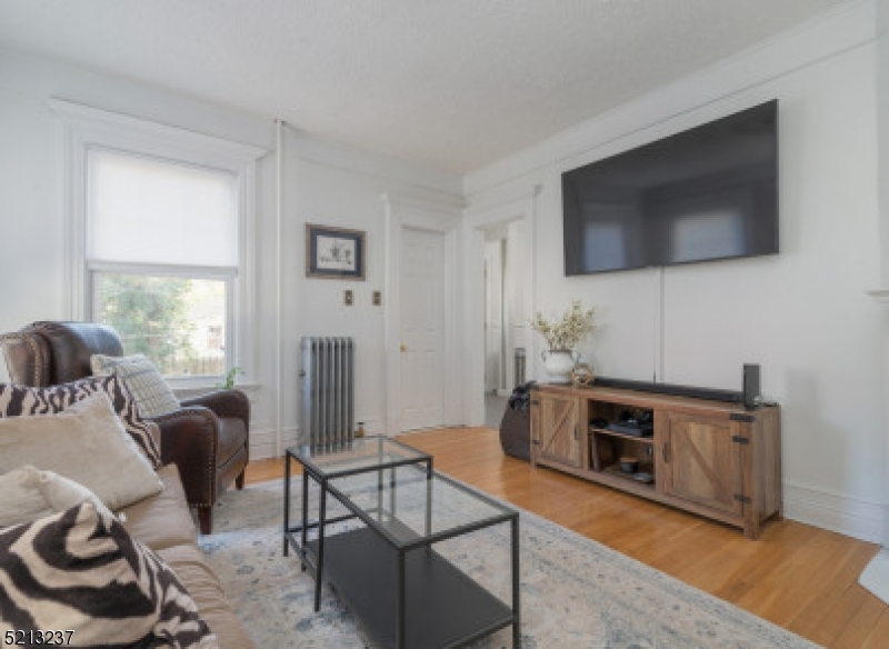 306 Springfield Avenue, Unit 1 Summit, NJ 07901 - Photo 6 of 8 a living room with furniture and a flat screen tv
