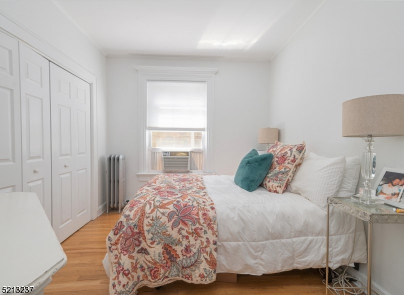 306 Springfield Avenue, Unit 1 Summit, NJ 07901 - Photo 8 of 8 a bedroom with a bed and a lamp