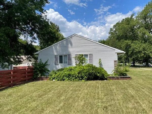 a view of a house with a yard and plants