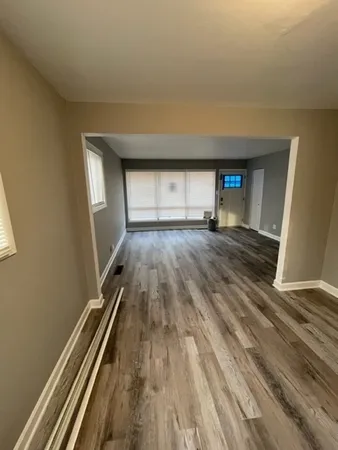 an empty room with wooden floor