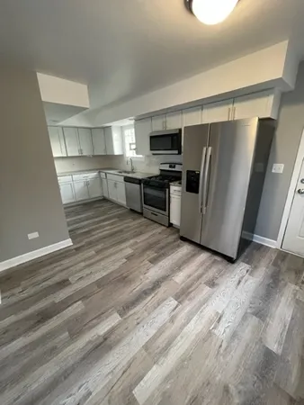 a kitchen with stainless steel appliances a refrigerator and a stove top oven