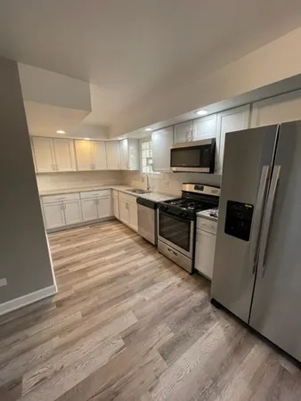 a kitchen with stainless steel appliances a refrigerator sink and microwave